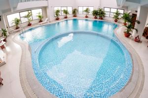 an overhead view of a large swimming pool in a hotel at Aurora Hotel Plaza in Bien Hoa