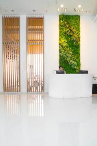 a man sitting at a desk in an office with a laptop at IW Hotel in Hong Kong