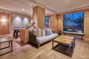 a living room with a couch and a table at Apexvilla-moon in Dongshan