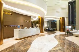 a lobby of a hotel with a reception desk at Ashley Wahid Hasyim Jakarta in Jakarta