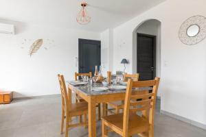 a dining room with a table and chairs at Le Domaine De Marie in Palasca