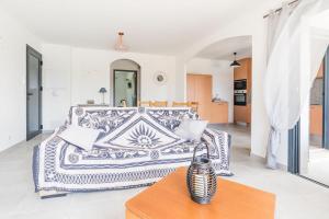 a living room with a couch and a table at Le Domaine De Marie in Palasca