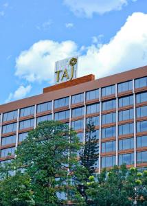 a tall building with a sign on top of it at Taj MG Road Bengaluru in Bengaluru
