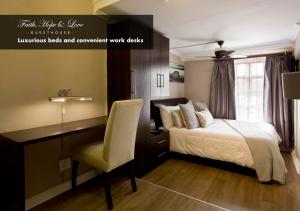 a bedroom with a bed and a desk and a chair at Faith, Hope & Love Self Catering in Port Elizabeth