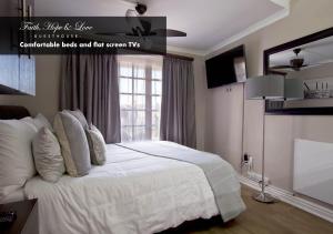 a bedroom with a bed with white sheets and a window at Faith, Hope & Love Self Catering in Port Elizabeth