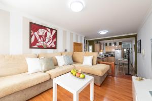 a living room with a couch and a table at Arinaga Luxury House Beach in Arinaga +17 photos
