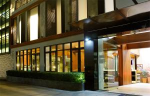 a building with large glass windows and a building at Izen Budget Hotel & Residence in Rayong