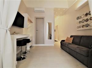 a living room with a couch and a fireplace at Royal Rooms Luxury Suite in Naples