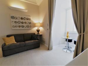 a living room with a couch and a table at Royal Rooms Luxury Suite in Naples