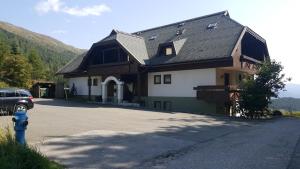 a house with a blue fire hydrant in front of it at Katschberghöhe 21 in Katschberghöhe