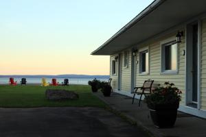 a house with a porch with a view of the ocean at Alpine Motor Inn in Alma