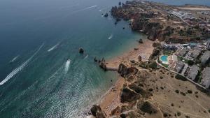 an aerial view of a beach with the ocean at Racing Mackerel Hostel in Lagos