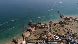 an aerial view of a beach and the ocean at Racing Mackerel Hostel in Lagos +31 photos