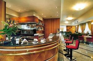 a kitchen filled with furniture and a large window at Hotel Valdarno in Montevarchi
