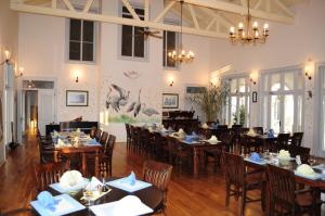 a dining room with tables and chairs in a restaurant at Delta Nature Resort in Tulcea