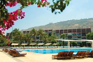a swimming pool with lounge chairs and a resort at Miramar Hotel Resort and Spa in Trâblous