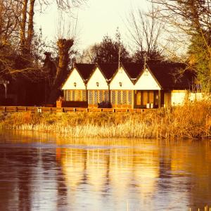 a house that is next to a body of water at The Wiremill Sleep Boutique in Felbridge