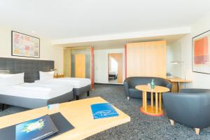 Postel nebo postele na pokoji v ubytování ABACUS Tierpark Hotel