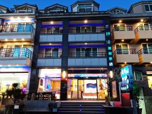 a large building with blue lights on it at Tranquil Sea Hotel in Kenting