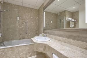 a bathroom with a sink and a shower and a tub at Best Western Plus Paris Orly Airport in Rungis +60 photos