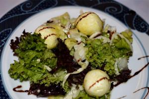 a plate of food with broccoli and potatoes on it at Hotel Das Schlössl in Bad Tölz