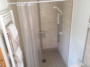 a bathroom with a shower with a shower curtain at Causeway Coast Country Cottage, Pet-friendly in Ballycastle