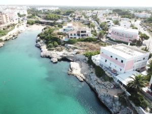 an aerial view of a beach and buildings next to the water at Cala Bona y Mar Blava in Ciutadella