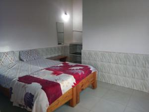 a bedroom with a wooden bed in a room at Padmaa Hampi Villa in Hampi