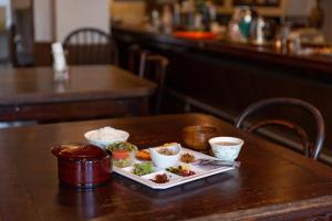 a plate of food on a table in a restaurant at Hotel Hanaya in Tanabe