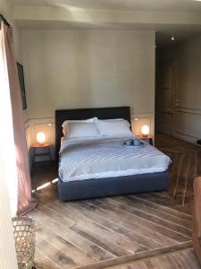 a bedroom with a bed with two lamps on the floor at Suites Menaggio in Menaggio