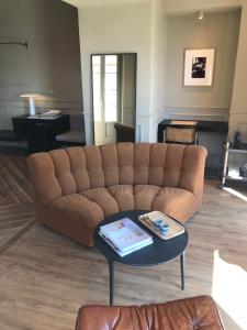 a living room with a brown couch and a table at Suites Menaggio in Menaggio