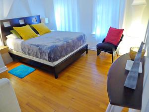 a bedroom with a bed and a table and a chair at Magical villa -Private pool-spa & garden in Lake Worth +30 photos