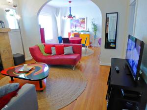 a living room with a red couch and a table at Magical villa -Private pool-spa & garden in Lake Worth
