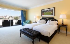 a hotel room with two beds and a large window at The Yeatman in Vila Nova de Gaia