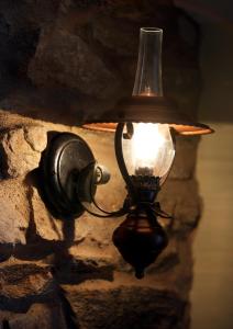 a light attached to a stone wall at Hotel Pazos Alba in Santiago de Compostela