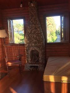 a living room with a fireplace and a chair at Jasmin Holiday House in Alexandria +53 photos