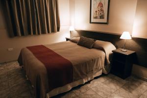 a hotel room with a large bed with two lamps at Vecchia Terra Apart Hotel in San Rafael