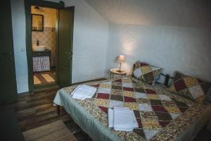 a bedroom with a bed with a quilt on it at Dacha in Uzhhorod