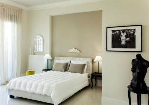 a large white bedroom with a large white bed at Maritina Apartment in Heraklio