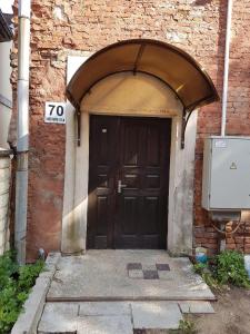 a door to a brick building with an arch over it at Viestura apartamenti in Daugavpils