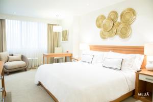 Rúm í herbergi á Hotel Melia Lima