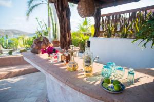 a table with wine bottles and glasses on it at Villa El Ensueño by La Casa Que Canta in Zihuatanejo