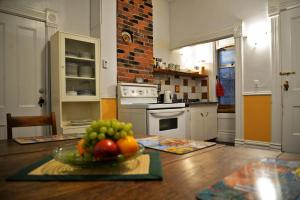 a kitchen with a bowl of fruit on a table at Vancouver Hideaway Guesthouse in Vancouver