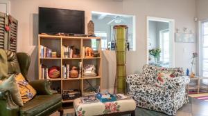 a living room with a tv on a book shelf at The Wild Rose in Miami