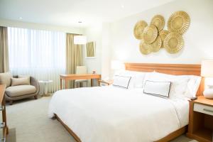 Rúm í herbergi á Hotel Melia Lima