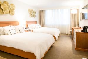 Rúm í herbergi á Hotel Melia Lima