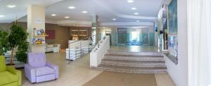 a lobby of a store with stairs and a chair at Hotel Holiday in Vasto