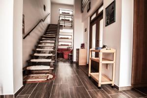 a hallway with a staircase with wooden floors at Apartmanovy Dom Martha a Domček Martuška in Liptovský Ján