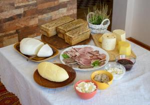 a table with bread and different types of food on it at Gospodarstwo Agroturystyczne Jacwing in Giby