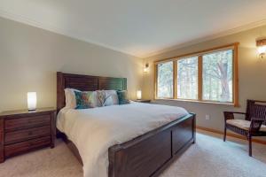 a bedroom with a large bed and a window at River Retreat - Permit #3517 in Estes Park